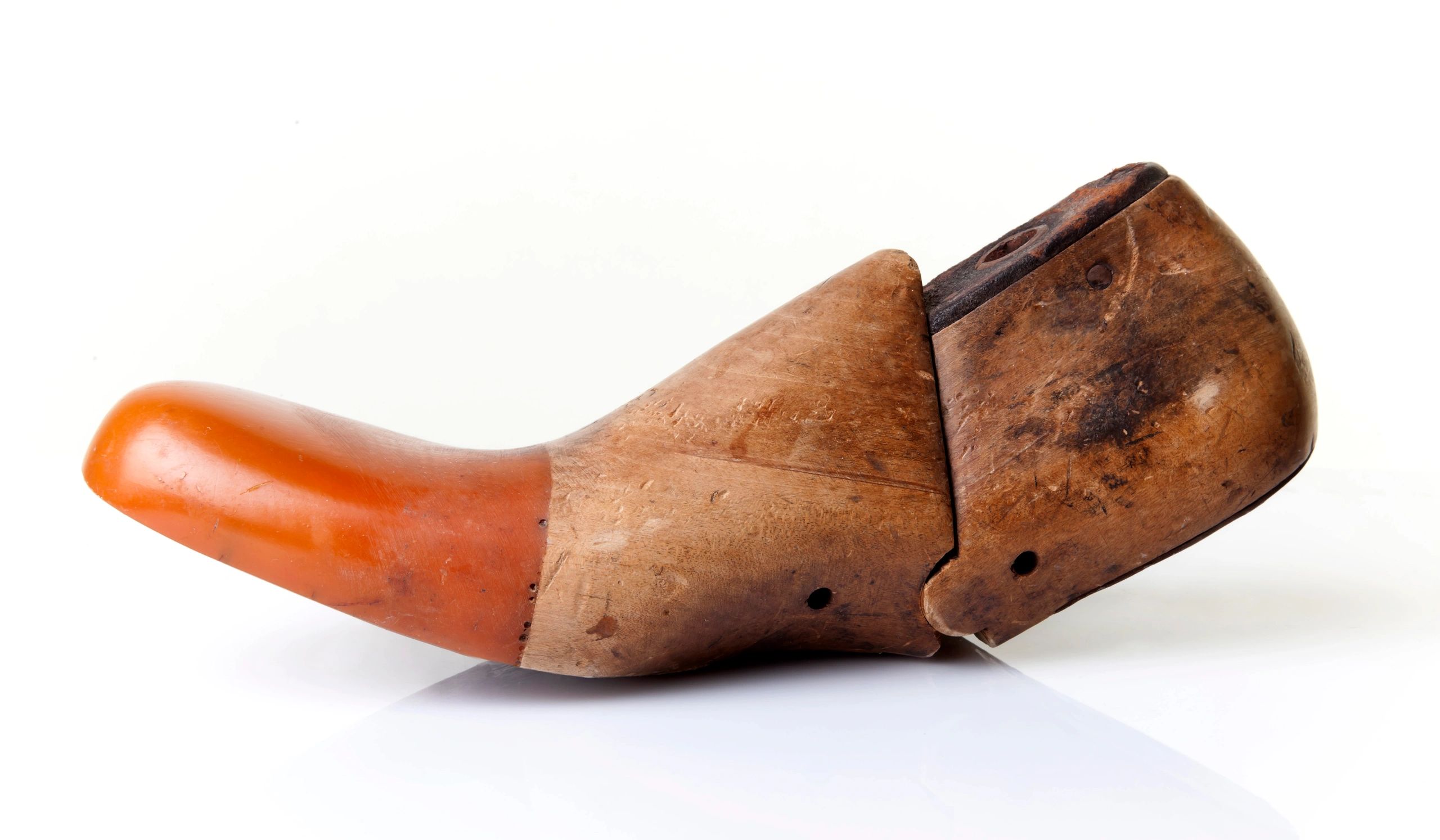 Traditional wooden shoe last on a dark background